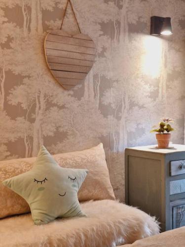 a bedroom with a bed with a pillow and a lamp at Casa do Mundo in Calhariz