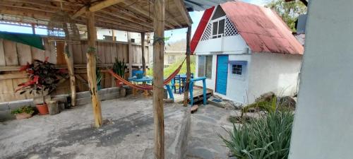 a patio with a hammock in front of a house at Cabañas Don Jorge - Cabaña Fragata in Puerto Baquerizo Moreno
