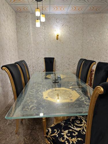 a dining room table with chairs and a sink on it at The Red Tree Family Guest House in Karachi