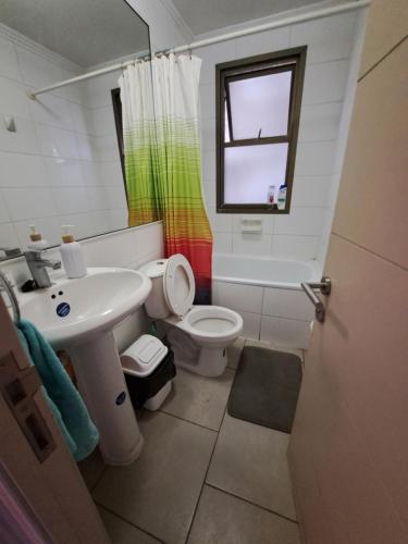 a bathroom with a sink and a toilet and a window at Casa aislada 1 piso Peñaflor-Malloco in Peñaflor