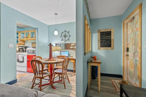 a kitchen and dining room with a table and chairs at Blue Bell Apartment Hotel in Fort Lauderdale