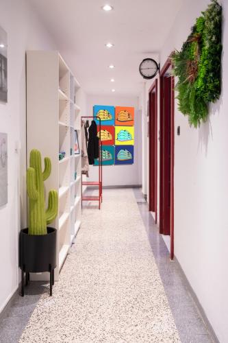 a hallway with a cactus in the middle of a room at Pop House - Spacious flat next to Cathedral & Lake in Como