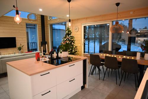 a kitchen and dining room with a christmas tree at Villa Golden House in Rovaniemi