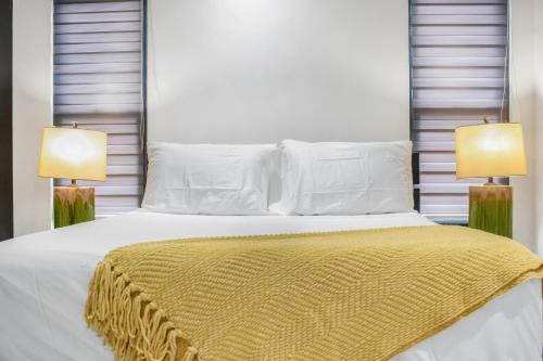a bedroom with a white bed with two lamps at Tranquility Love Bay in Richmond