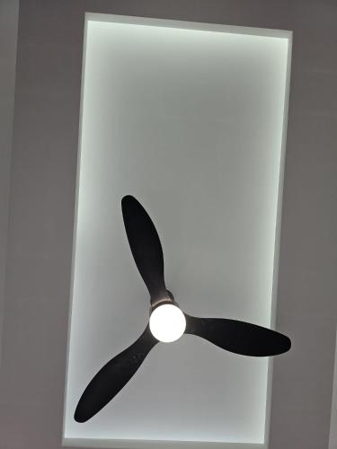 a black ceiling fan hanging from a ceiling at Tranquility Love Bay in Richmond