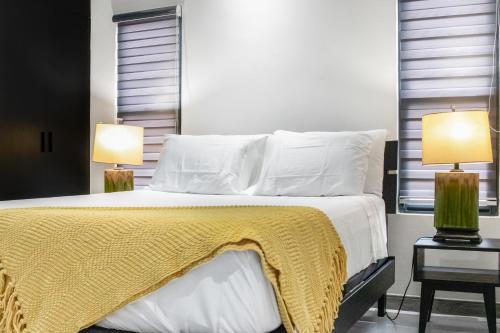a bedroom with a bed with a yellow blanket on it at Tranquility Love Bay in Richmond