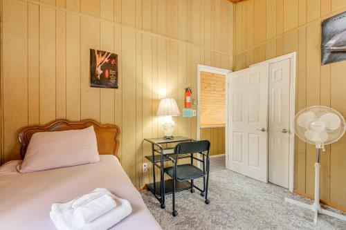 a bedroom with a bed and a desk with a lamp at Near Hiking and Skiing Home in Wilmington! in Wilmington