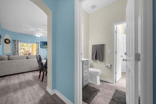 a living room with a couch and a bathroom at Lazy River Resort Townhome in Davenport