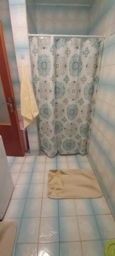 a bathroom with a rug on a tiled floor at Apartmán Mela in Bardejov