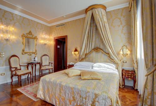 a bedroom with a bed with a canopy at Canal Grande in Venice
