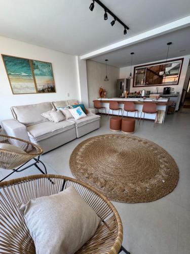 a living room with a couch and a table at Casa João de Barro in Itacaré