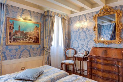 a bedroom with a bed and a mirror and a chair at Canal Grande in Venice
