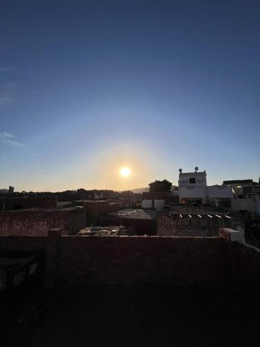 a view of the sun setting over a city at Hashem Nubian Guest House in Aswan