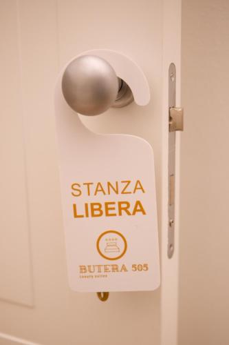 a sign on a door that reads stanza libertera at Butera 505-Luxury Suites in Bagheria