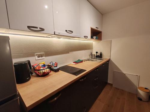a kitchen with a wooden counter top and a sink at Surčin Central Stay in Surčin