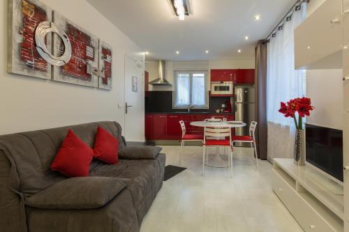 a living room with a couch and a table at Hotel De L'Horloge in Paris
