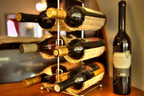 a bunch of bottles of wine on a table at Boutique Hotel Sulić in Međugorje