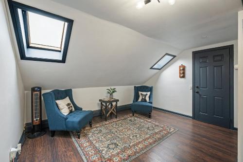 a living room with two blue chairs and a rug at The Gilmore, Providence RI in Providence