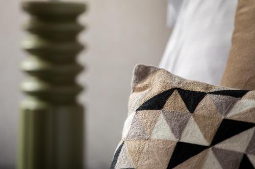 a close up of a pillow on a bed at Crown Street Aparthotel 2 in Halifax