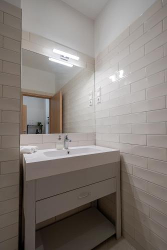 a bathroom with a sink and a mirror at Hama Boutique Stays in Budapest