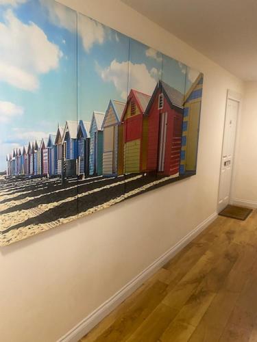 a painting of buildings on a wall in a room at Sunrise at The Bay Filey in Filey
