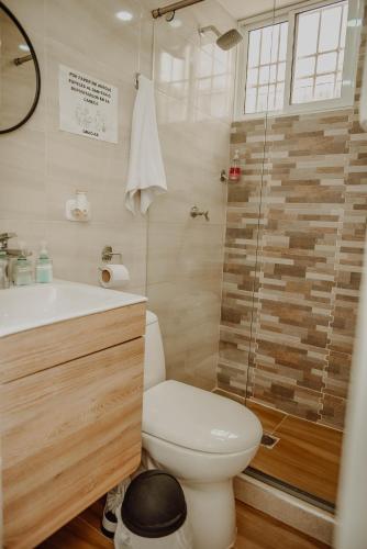 a bathroom with a toilet and a sink and a shower at Comfort in Valledupar