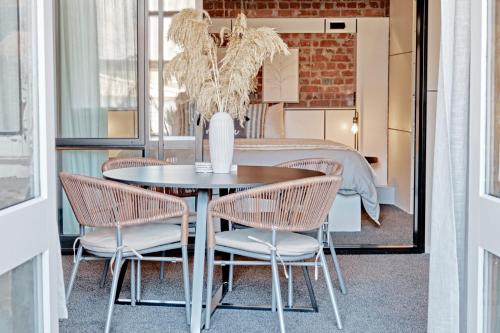 a dining room with a table and two chairs at The Loft on Cuba in Wellington