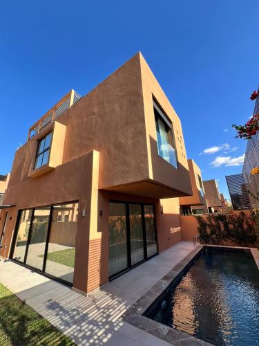 a house with a swimming pool in front of it at Villa Tagana in Marrakesh