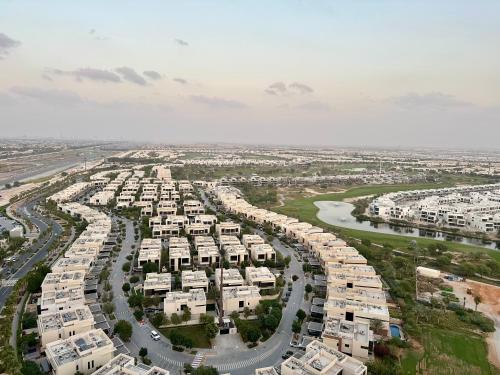 an aerial view of a large apartment complex at Cozy Golf & Lake View 1BR Apartment,Damac Hills 1 in Dubai
