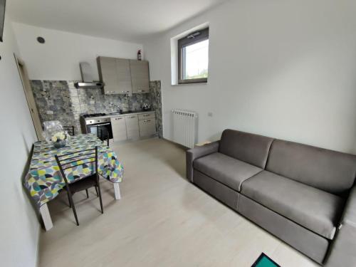 a living room with a table and a couch at Villa Maria in Bagnoli Irpino