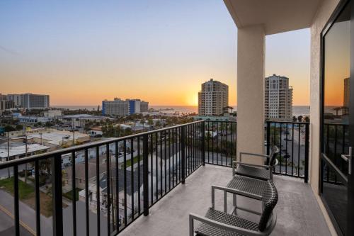 a balcony with two chairs and a view of the city at Courtyard by Marriott Clearwater Beach in Clearwater Beach