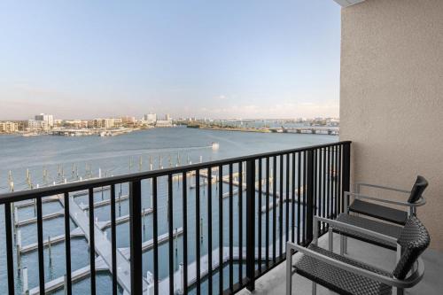 a balcony with a chair and a view of the water at Courtyard by Marriott Clearwater Beach in Clearwater Beach