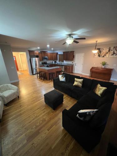 a living room with a couch and a table at Spacious Gorgeous 3bd home with large deck Close to EVERYTHING in Atlanta