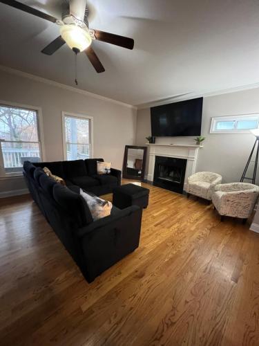 a living room with a couch and a ceiling fan at Spacious Gorgeous 3bd home with large deck Close to EVERYTHING in Atlanta