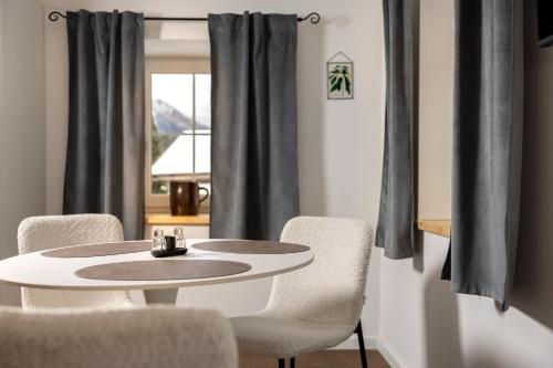a table and chairs in a room with a window at Defereggerhof St Veit in Defereggen in Feld