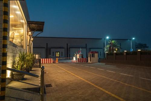 a building at night with lights on a street at Best Western Faisalabad in Faisalabad