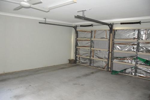 an empty room with a ceiling fan and shelves at Lazy Choose-Day - Bring your own linen. in Hat Head