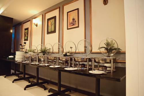 a buffet line in a restaurant with plates and dishes at Best Western Faisalabad in Faisalabad