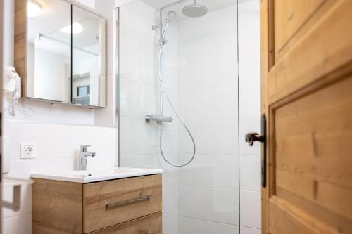 a bathroom with a sink and a shower at Defereggerhof St Veit in Defereggen in Feld