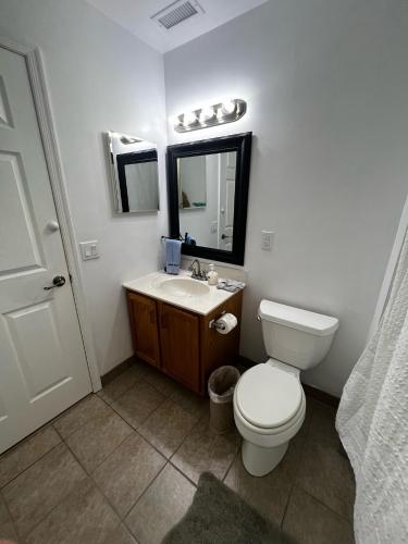 a bathroom with a toilet and a sink and a mirror at Perfect 5 Star Beach Block with Hot Tub in Atlantic City