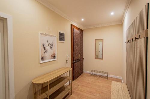 a hallway with a wooden bench and a door at Radost Residence The Heart of Unique Living in Prague