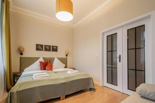 a bedroom with a bed with two towels on it at Radost Residence The Heart of Unique Living in Prague