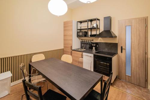 a kitchen with a table and chairs in a room at Radost Residence The Heart of Unique Living in Prague