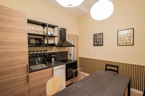 a kitchen with a table and a counter top at Radost Residence The Heart of Unique Living in Prague