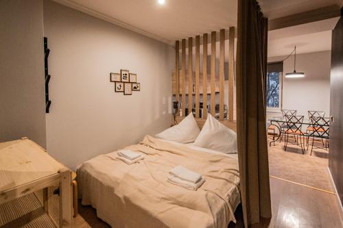 a bedroom with a bed with two towels on it at Radost Residence The Heart of Unique Living in Prague