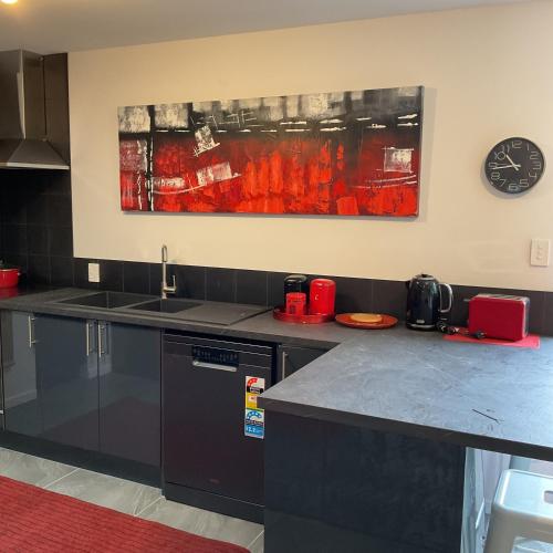 a kitchen with a sink and a counter top at MOWA Art House Apartment in Huonville