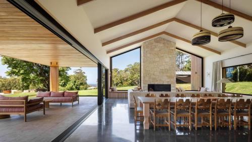 an open living room with a table and chairs at Cedar Hill in Newrybar
