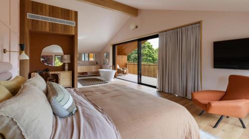 a bedroom with a large bed and a television at Cedar Hill in Newrybar