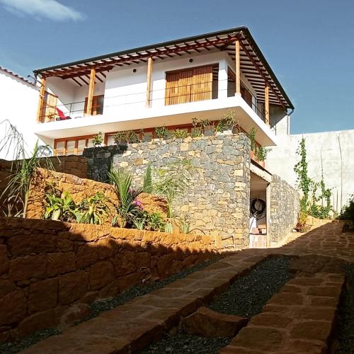a house on top of a stone wall at Casa Peak Barichara in Barichara