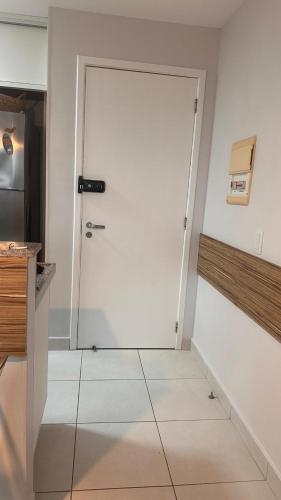 a white door in a kitchen with a tile floor at VG Sun Cumbuco in Cumbuco